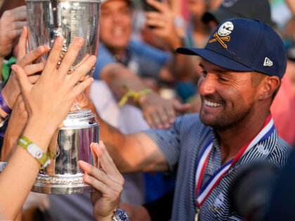 Bryson DeChambeau shows the trophy to fans after winning the U.S. Open golf tournament Sun