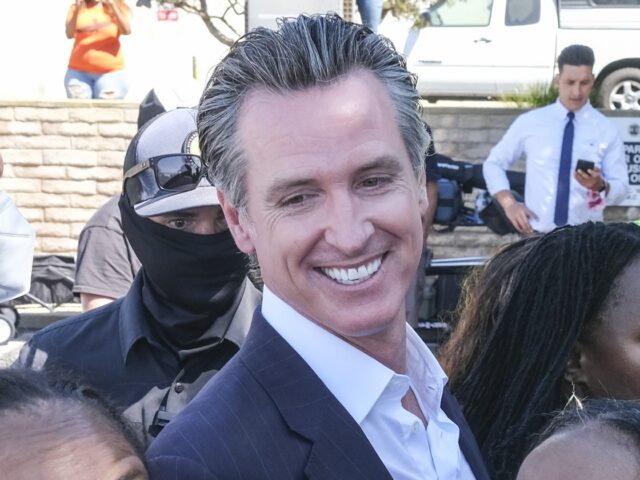 California Gov. Gavin Newsom takes photos with members of Bruce's family and Justice