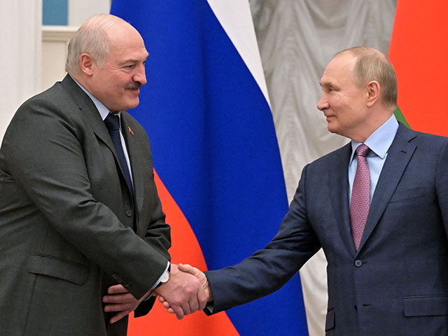 Russia's President Vladimir Putin (R) shakes hands with his Belarus counterpart Alexander