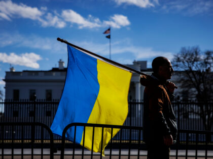 WASHINGTON, DC - FEBRUARY 25: A man with a Ukrainian flag stands on Pennsylvania Avenue in