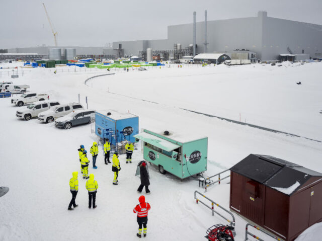 Workers gather at a food truck in the snow at the Northvolt Ett AB plant in Skelleftea, Sw