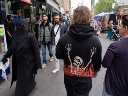 Burning skeleton hoodie street scene at Whitechapel Market on Whitechapel High Street on 2