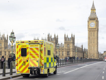 An ambulance crosses Westminster Bridge during a strike by junior doctors at St Thomas&#03