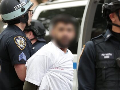 A pro-Palestinian activist is arrested by NYPD officers during a march to mark the 76th an