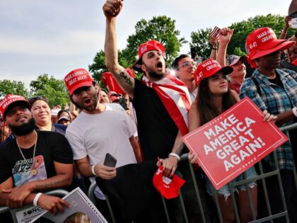 NEW YORK, NEW YORK - MAY 23: Supporters of former President Donald Trump watch as he holds