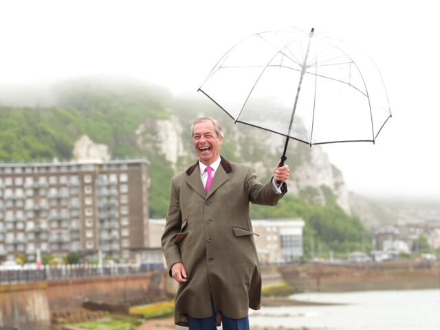 Nigel Farage poses for photographers in Dover, after announcing Howard Cox as the Reform U