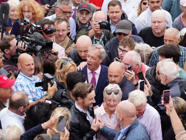 Leader of Reform UK Nigel Farage surrounded by crowds as he departs the launch of his Gene