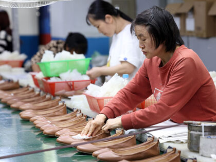 Employees make leather shoes for export at a workshop of Fujian Tenglong Shoe Industry Co