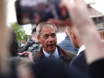 A member of the public takes a photograph on a phone of, Leader of Reform UK Nigel Farage