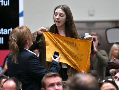 MANCHESTER, ENGLAND - JUNE 13: A protester holds up a banner saying "Youth Deserve Be
