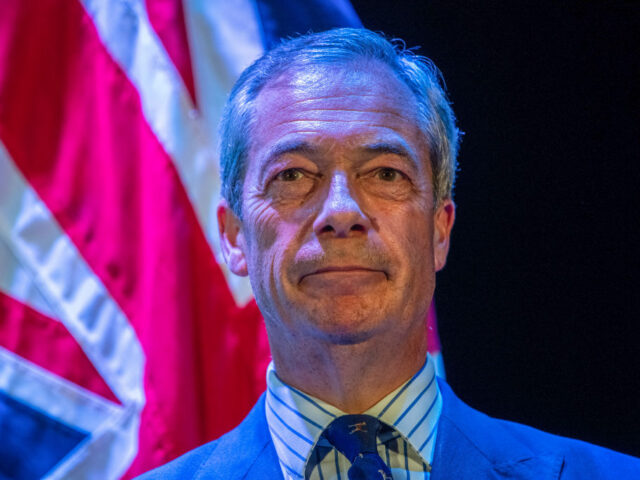 Nigel Farage, leader of Reform UK, speaks to local residents during a town hall general el