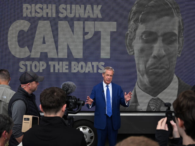Leader of Reform UK Nigel Farage stands in front of a van reading "Rishi Sunak won't stop