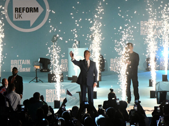 Pyrotechnics go off as Reform UK leader Nigel Farage arrives to deliver a speech during th