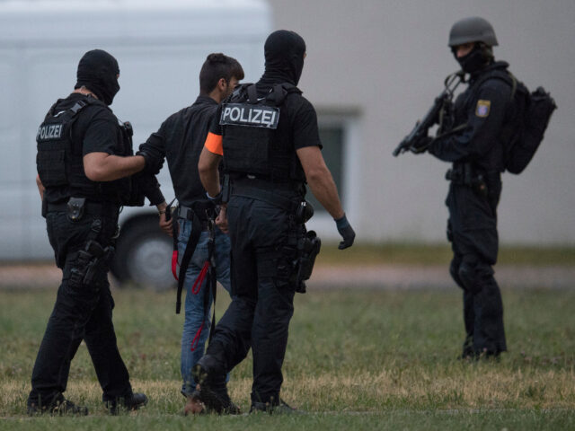 Police officers of a special unit escort Iraqi asylum seeker Ali Bashar, who is suspected