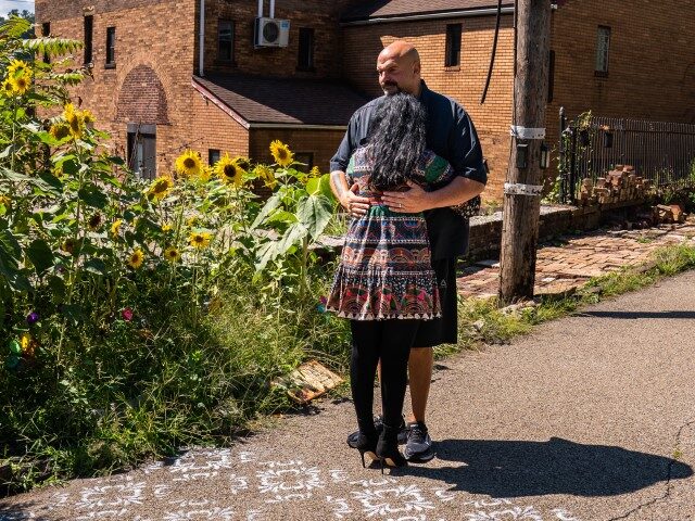 Gisele and John Fetterman share a hug outside their home in Braddock, PA on Monday, Septem