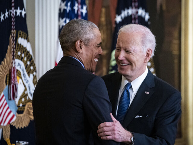 U.S. President Joe Biden and former U.S. President Barack Obama, left, embrace during an e