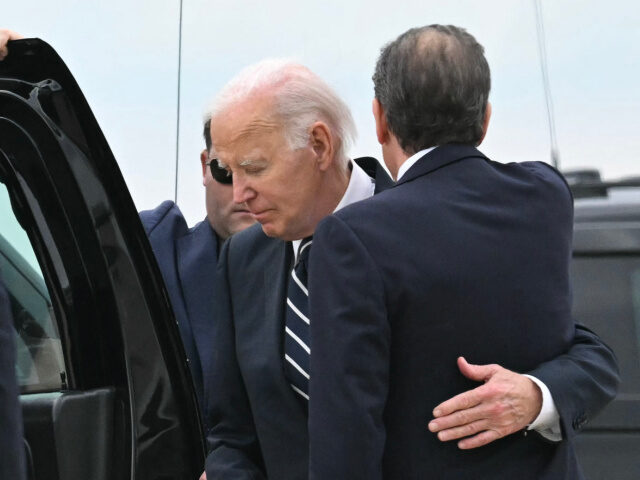 US President Joe Biden hugs his son Hunter Biden upon arrival at Delaware Air National Gua