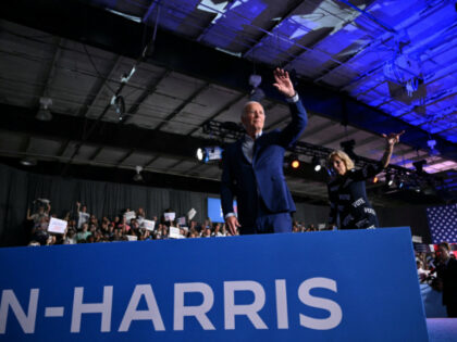 US President Joe Biden and First Lady Jill Biden wave as they leave the stage after a camp