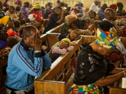 Churchgoers pray during a morning service at the Saint Charles Catholic Church, the site o