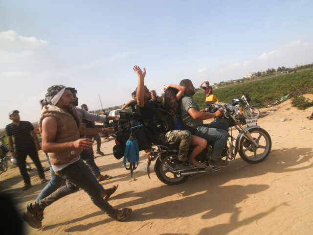 Palestinians transport a captured Israeli civilian, Noa Argamani, on a motorcycle from sou