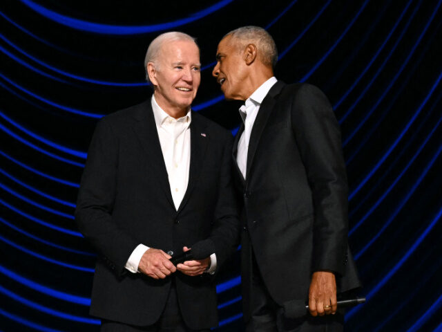 US President Joe Biden (L) stands with former US President Barack Obama onstage during a c