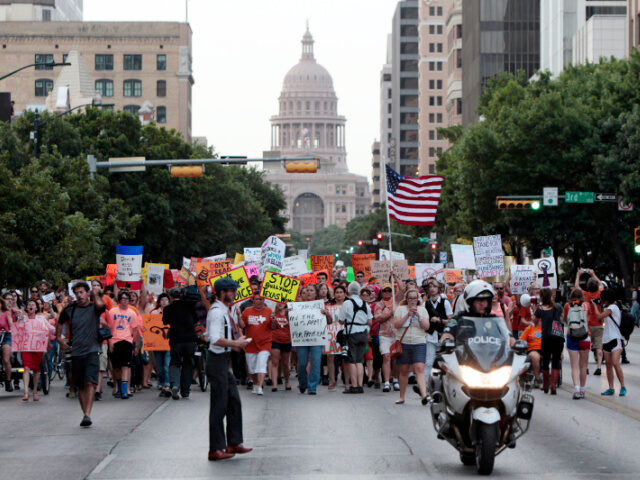 Pro-choice protesters march down Congress Avenue and back to the Texas state capitol as pr