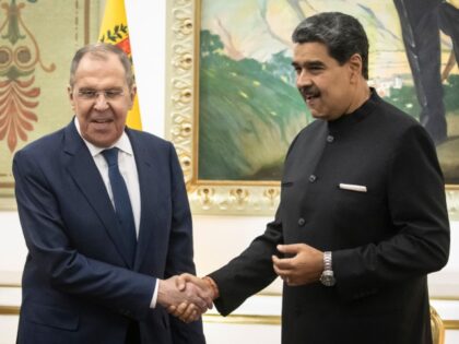 Nicolas Maduro, Venezuela's president, right, shakes hands with Sergei Lavrov, Russia