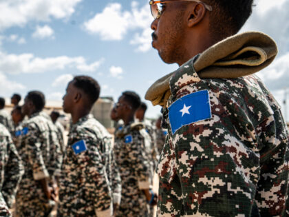 TOPSHOT - A Somali National Army soldier stands at attention during the morning briefing f