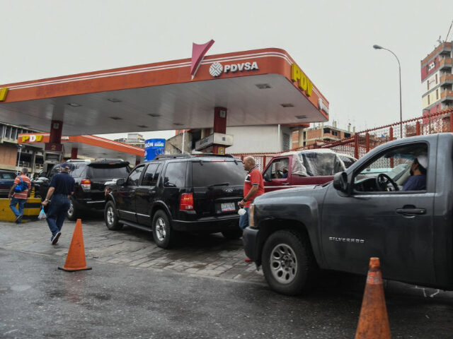 Customers wait in line to refuel vehicles at a Petroleos de Venezuela SA (PDVSA) gas stati