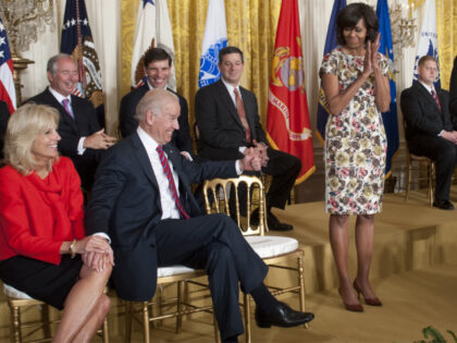 US Vice President Joe Biden (2L) gives a thumbs-up alongside his wife, Jill Biden (L), as