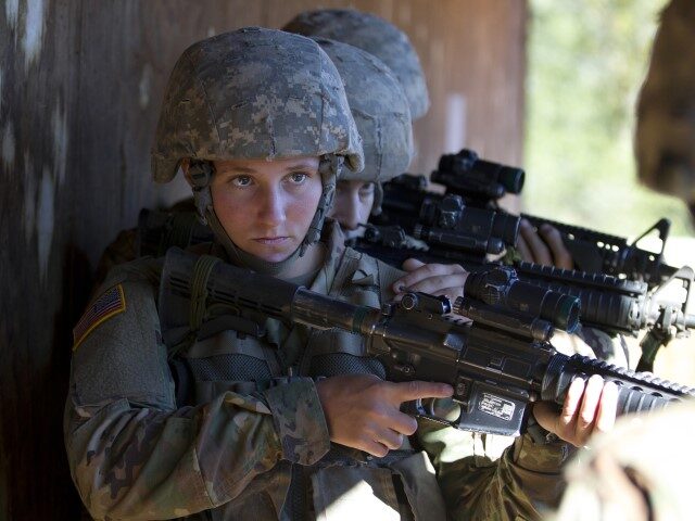 In this Oct. 4, 2017, photo, a female U.S. Army recruit practices building clearing tactic
