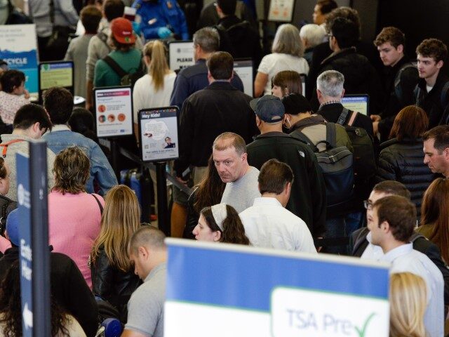 A long line of travelers wait for the TSA security check point at O'Hare Internationa