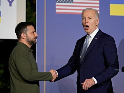 President Joe Biden answers no to a question about pardoning his son as he shakes hands wi