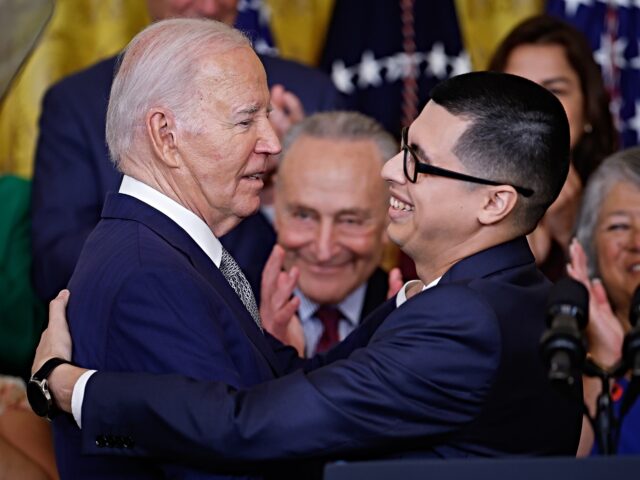WASHINGTON, DC - JUNE 18: U.S. President Joe Biden is embraced by Javier Quiroz Castro aft