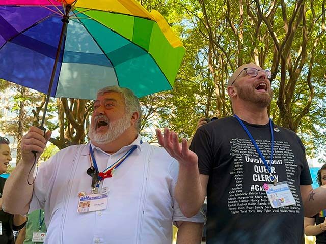The Rev. David Meredith, left, and the Rev. Austin Adkinson sing during a gathering of tho