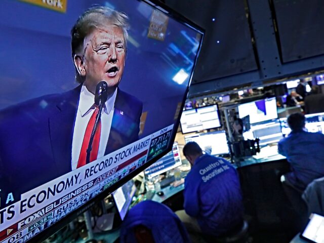 A television screen on the floor of the New York Stock Exchange shows President Donald Tru