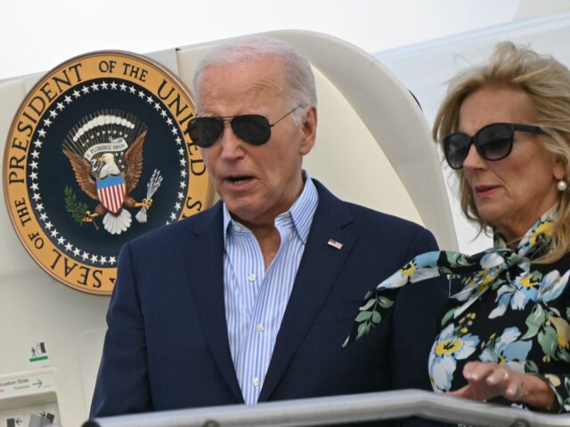 US President Joe Biden and First Lady Jill Biden step off Air Force One upon arrival at Mc