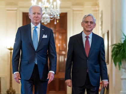 President Joe Biden and Attorney General Merrick Garland walk through the Cross Hall to at