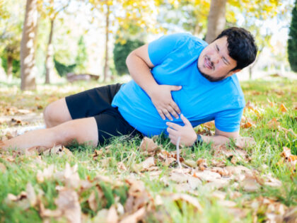 A man is on the ground with chest pain (Getty/Stock Photo).