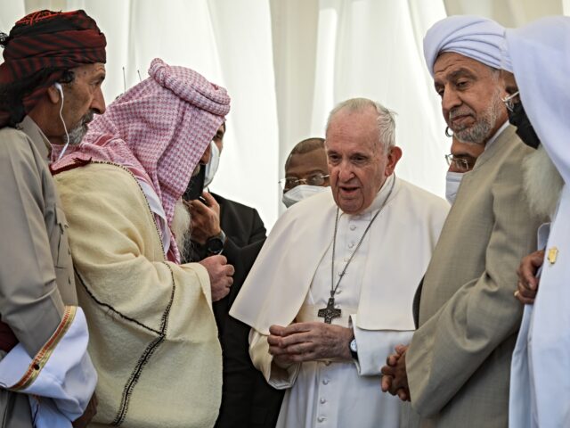 06 March 2021, Iraq, Nasiriyah: Pope Francis (C) speaks with religious clerics from differ
