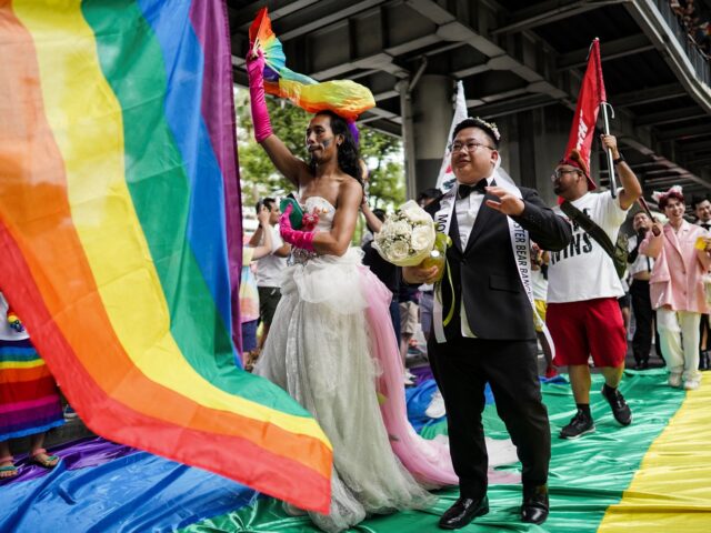 LGBT+ couples are marching with banners calling for the Marriage Equality bill during the