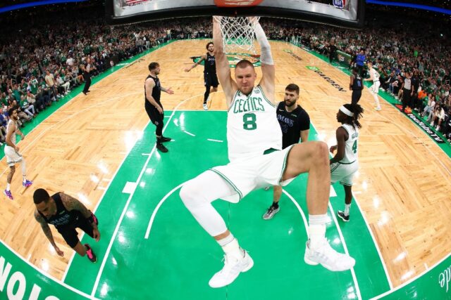 Boston's Kristaps Porzingis dunks in the first quarter of the Celtics' victory over Dallas