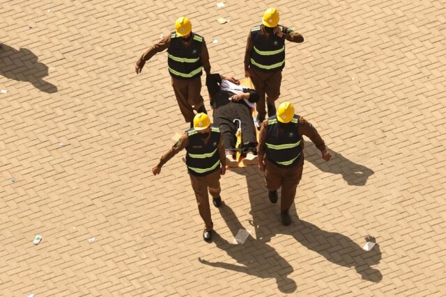 A man affected by scorching heat is stretchered away during the hajj pilgrimage