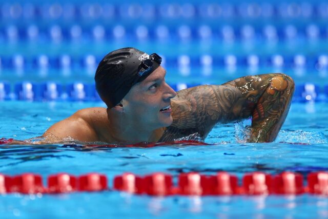 Caeleb Dressel checks the scoreboard after the men's 100m freestyle final at the US Olympi