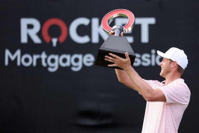 Cameron Davis of Australia celebrates with the trophy after winning his second PGA Rocket