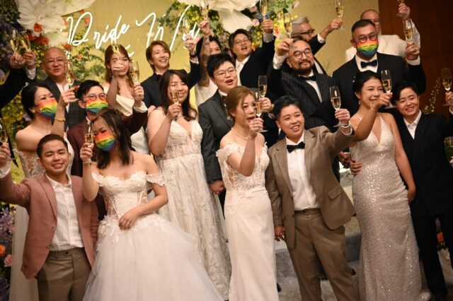 The couples exchanged marriage vows in a hotel ballroom with the officiant joining via vid