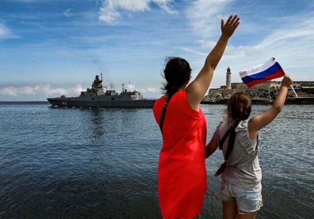 Cubans wave as Russian ships leave the Havana harbor after a five-day visit