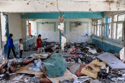 Gaza children inspect damage to a UN-run school being used as a shelter