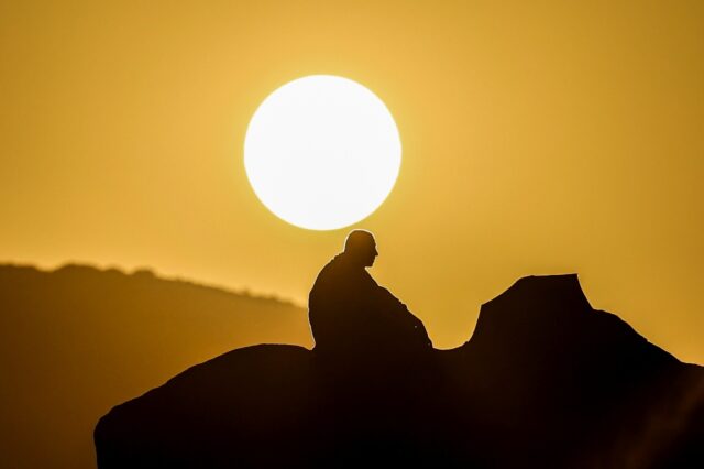 A Muslim pilgrim prays at dawn on Mount Arafat during this year's hajj