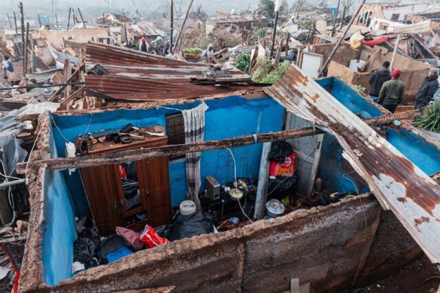 People salvage their belongings in the aftermath of torrential rain and flooding, north of